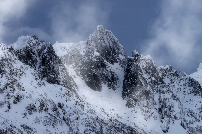 mountain peaks engulfed with light cloud