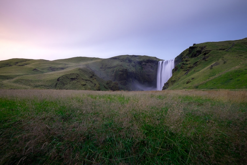 pastel coloured sunset at skogarfoss waterfall in Iceland