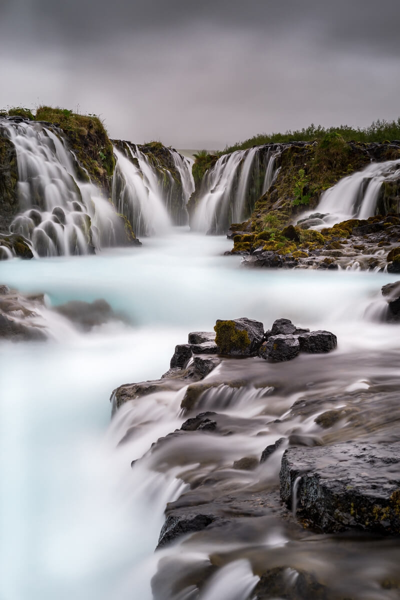 Brurafoss waterfall, small unique waterfall with vibrant blue water
