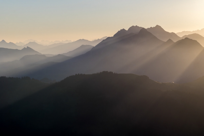 Mountain peaks, light beams Switzerland.