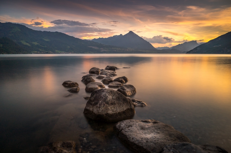 Lake of Thun during a fiery sunset. The Niesen mountain stands prominently in the distance.