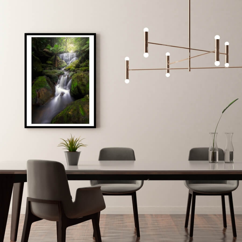 Teared waterfall in vibrant green fern forest