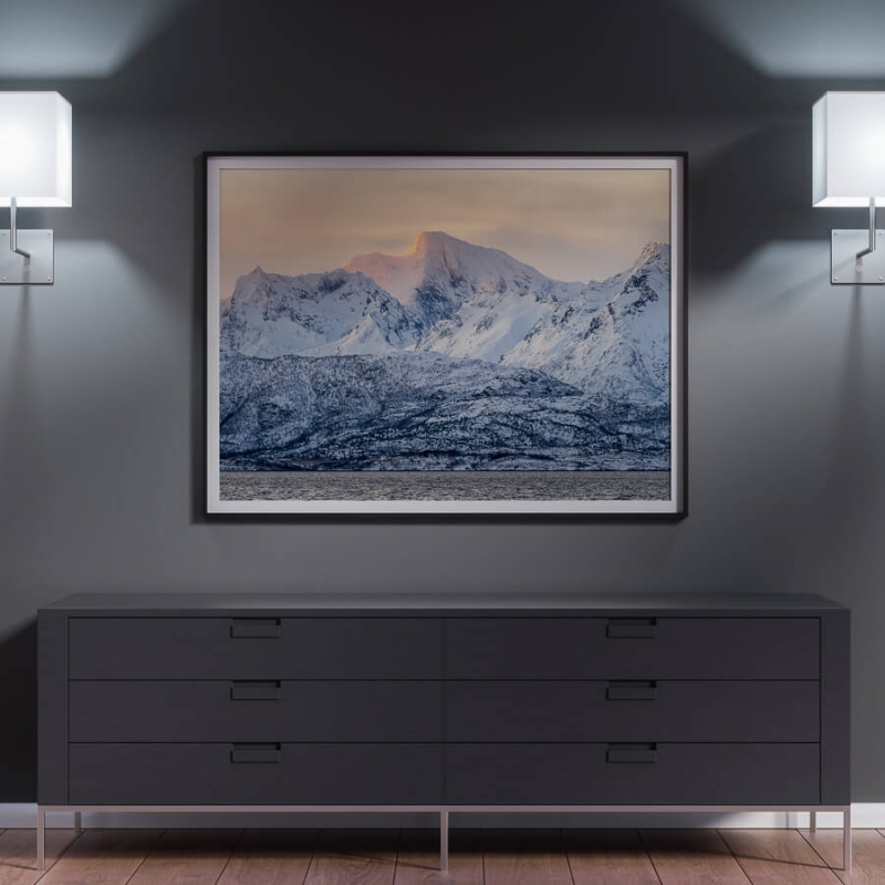 Winter sunrise, snow covered mountains with alpine glow.