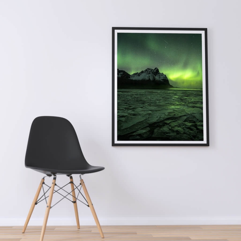 Aurora Borealis over vestrahorn mountain reflecting of broken sheet ice