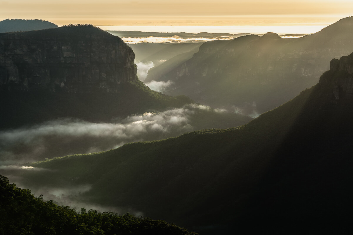 Rays of light illuminate the valley floor in the Blue Mountains